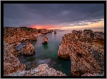 Wybrzeże, Skały, Zachód słońca, Morze, Region Algarve, Portugalia